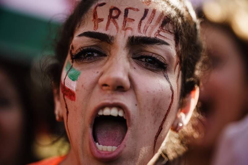 A demonstrator with the word 'freedom' in German inscribed on her forehead. EPA