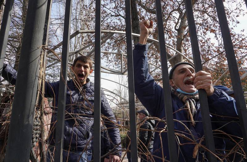 Participants of an opposition rally demanding the resignation of Armenian Prime Minister Nikol Pashinyan gather behind a fence while arguing with Pashinyan's supporters in Yerevan, Armenia. Reuters