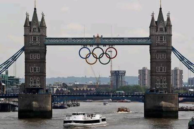 The Olympic rings are seen atop the iconic Tower Bridge over river Thames in London, after they were lowered into position, coinciding with one month to go until the start of London 2012 Games, Wednesday, June 27, 2012. The giant rings, which are fully retractable to allow for tall ships to pass through the bridge, will remain in position for the duration of the Games. (AP Photo/Lefteris Pitarakis) *** Local Caption *** Britain London 2012 Olympics.JPEG-09e02.jpg