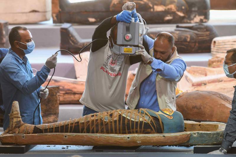 Archaeologists x-ray a mummy, wrapped in a burial shroud adorned with brightly coloured hieroglyphics pictorials. AFP