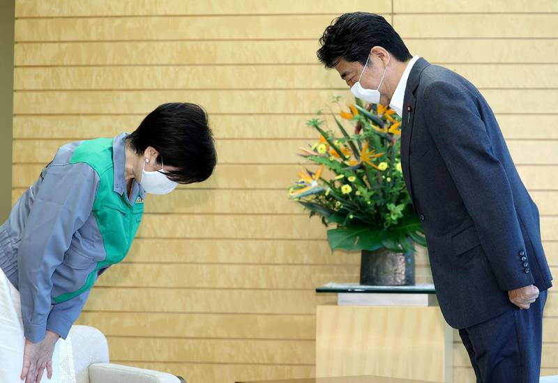 Japan's Prime Minister Shinzo Abe (R) and Tokyo governor Yuriko Koike (L) bow to greet each other during a meeting at the prime minister's official residence in Tokyo, on July 6, 2020. Tokyo governor Yuriko Koike declared victory on July 5, 2020 in the vote to elect the leader of one of the world's most populous cities and immediately vowed to step up the fight against a recent coronavirus resurgence. - Japan OUT
 / AFP / JIJI PRESS / STR
