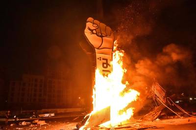 The ‘Revolution fist’, symbol of Lebanon’s October 2019 uprising, burns after it was set on fire during clashes between anti-government protesters and supporters of former prime minister Saad Hariri, in the capital Beirut's central Martyr's square. AFP