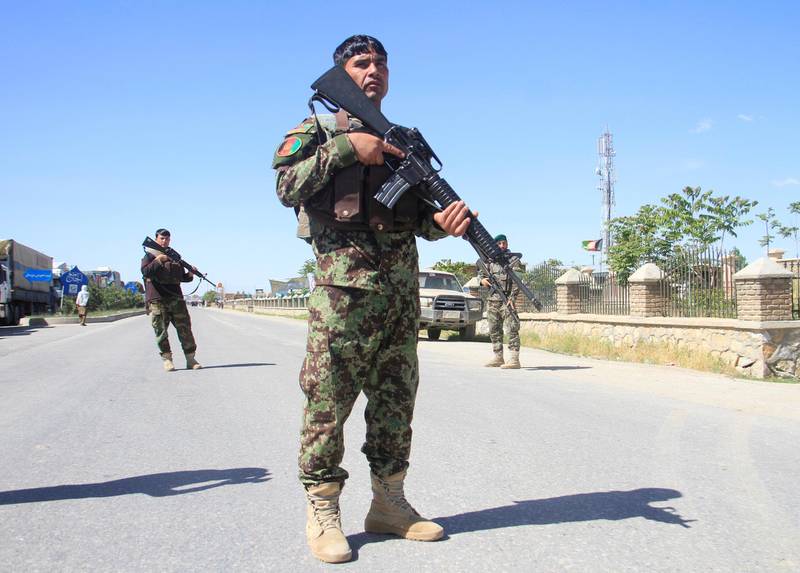 FILE PHOTO: Afghan National Army officers stand guard at the site of a blast in Ghazni province, Afghanistan May 18, 2020. REUTERS/Mustafa Andaleb/File Photo
