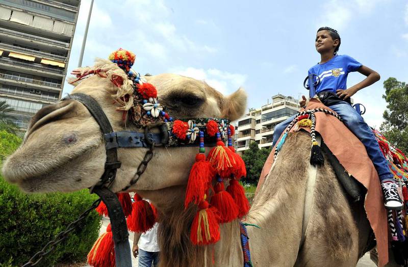 A Lebanese child rides a camel during celebrations in Beirut, Lebanon. Wael Hamzeh/EPA