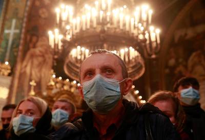 Believers attend a service on the eve of Orthodox Christmas at the Volodymyrsky Cathedral in Kyiv, Ukraine. Reuters