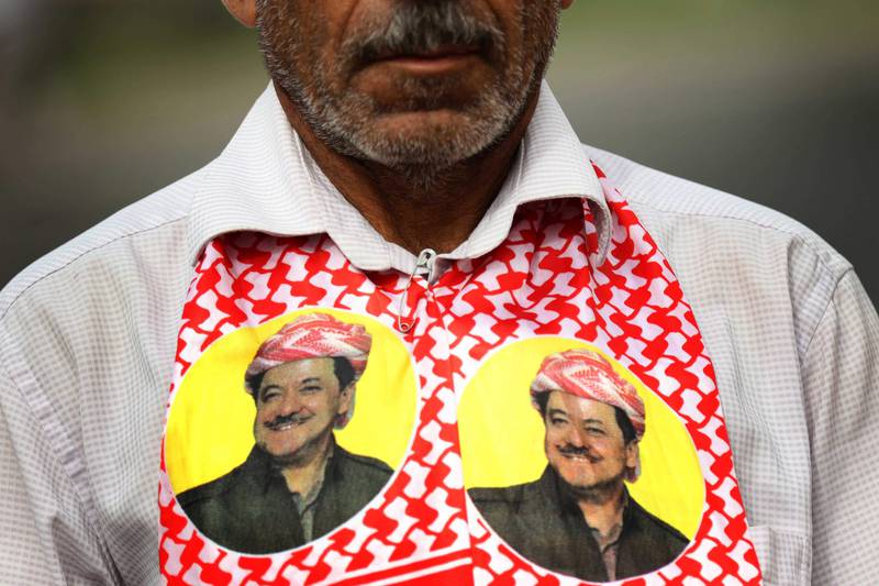 An Iraqi Kurd wears a scarf bearing a portrait of the Iraqi Kurdish leader Massud Barzani, during a protest in support of him, in Arbil, the capital of autonomous Iraqi Kurdistan, on October 30, 2017. 
Long-time Kurdish leader Massud Barzani, the architect of the referendum, announced on October 29, 2017 he is stepping down after it led to Iraq's recapture of almost all disputed territories that had been under Kurdish control. / AFP PHOTO / SAFIN HAMED