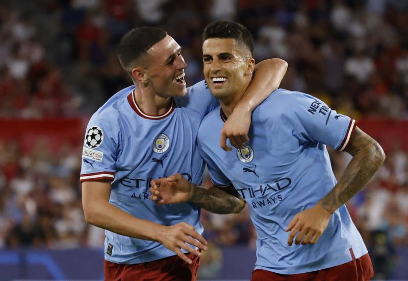 Phil Foden celebrates scoring City's second goal with Joao Cancelo. Reuters