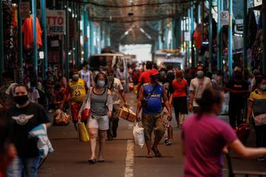 People walk through a public market in the Philippines. Asia's GDP will decline by 0.7 per cent in 2020. EPA