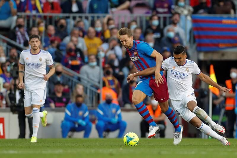 Barcelona striker Luuk De Jong battles for the ball with Real Madrid midfielder Casemiro. AFP