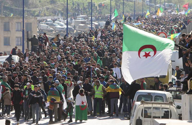 Demonstrators carry national flags as they gather in the town of Kherrata, marking two years since the start of a mass protest movement there demanding political change, Algeria. Reuters