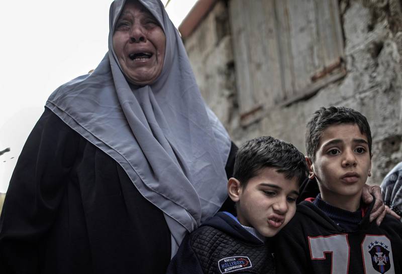 epa06436146 Sons and mother of Palestinian fisherman, Abdallah Zidan, mourn during his funeral in the streets of Al Shateaa refugee camp, Gaza, Gaza Strip, 13 January 2018. Zidan, 33, was reportedly shot dead on 13 January while he was fishing on a boat in the beach of Rafah town near the border between Egypt and southern Gaza Strip. Palestinian officials called for an immediate investigation into the incident.  EPA/MOHAMMED SABER