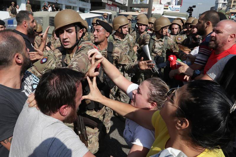 Anti-government protesters scuffle with Lebanese army soldiers in the town of Zouk Mosbeh, north of Beirut. AP Photo