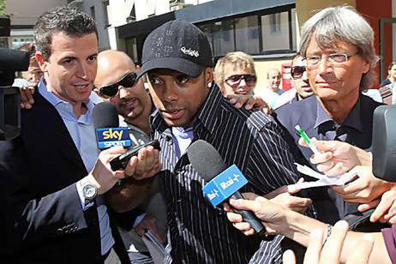 Robinho, centre, the Brazil forward, leaves the Sant' Antonio Abate hospital in Milan yesterday after completing his medical ahead of his move to AC Milan, the Serie A club, from Manchester City.