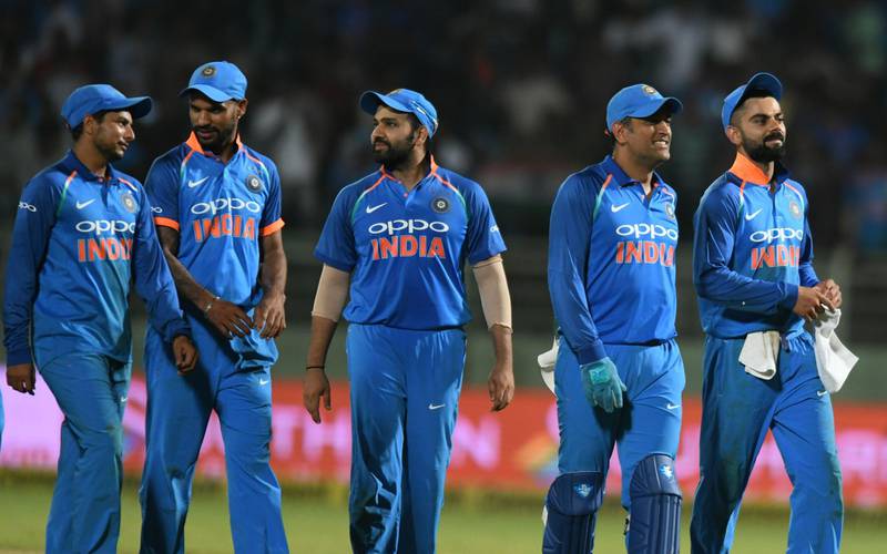 Indian cricket captain Virat Kohli (R) leaves the field with teammates after they tied against West Indies during the second one day international (ODI) cricket match between India and West Indies at the Dr. Y.S. Rajasekhara Reddy ACA-VDCA Cricket Stadium in Visakhapatnam on October 24, 2018. / AFP / NOAH SEELAM
