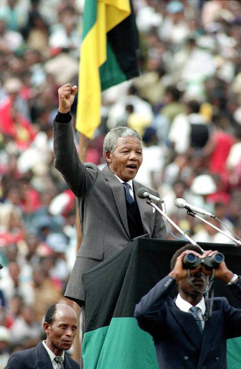 February. 13, 1990: Mandela salutes to 120,000 ANC supporters packing Soccer City stadium in the Soweto, shortly after his release from 27 years in prison. AP Photo