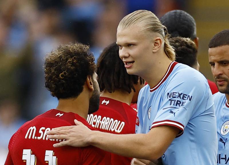  Liverpool's Mohamed Salah shakes hands with Manchester City's Erling Haaland before the match . Action Images