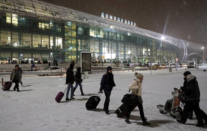 Russian passengers walk outside of the Domodedovo airport terminal in the Moscow region, Russia. Yuri Kochetkov / EPA