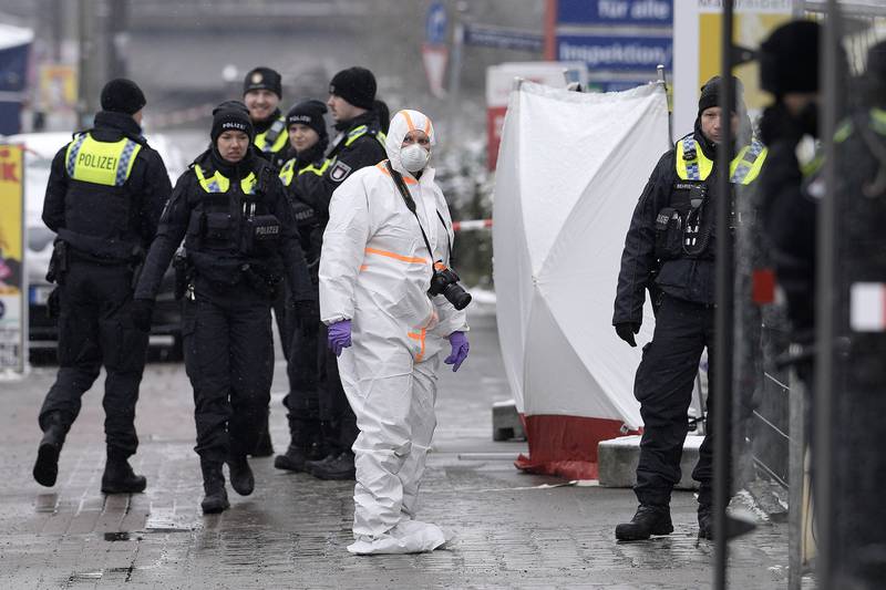 Officers outside the Jehovah's Witness building in Hamburg where several people were shot dead. AP