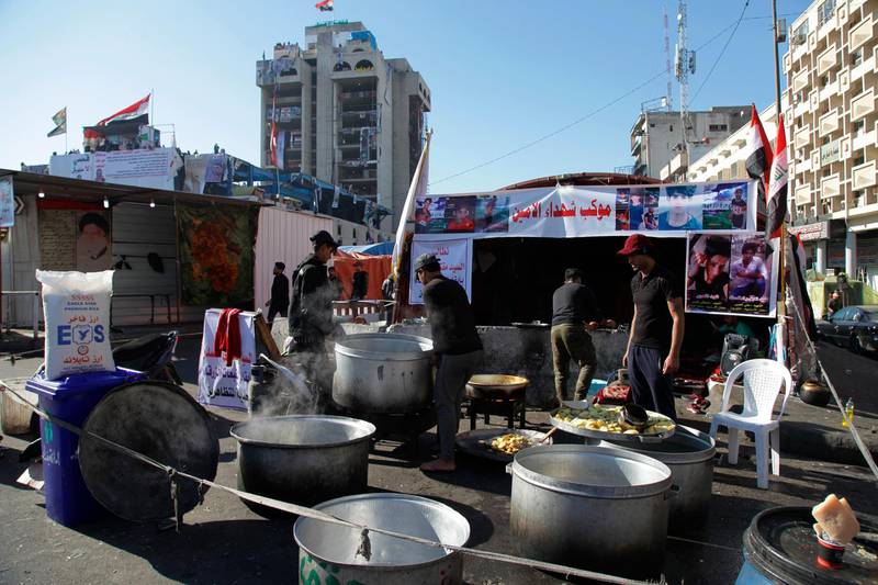 Volunteers prepare free food to anti-government protesters in Tahrir Square during ongoing protests in Baghdad. AP