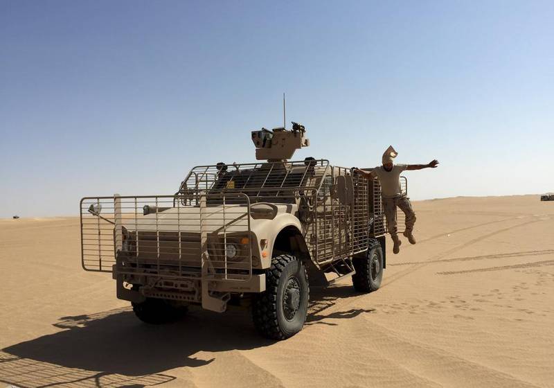 An Emirati soldier jumps from an armoured vehicle in Marib. Noah Browning / Reuters