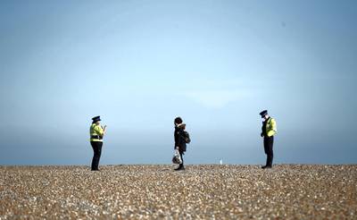  Police community support officers talk to a person as the spread of the coronavirus disease (COVID-19) continues, Brighton, Britain, April 4, 2020. REUTERS/Peter Cziborra
