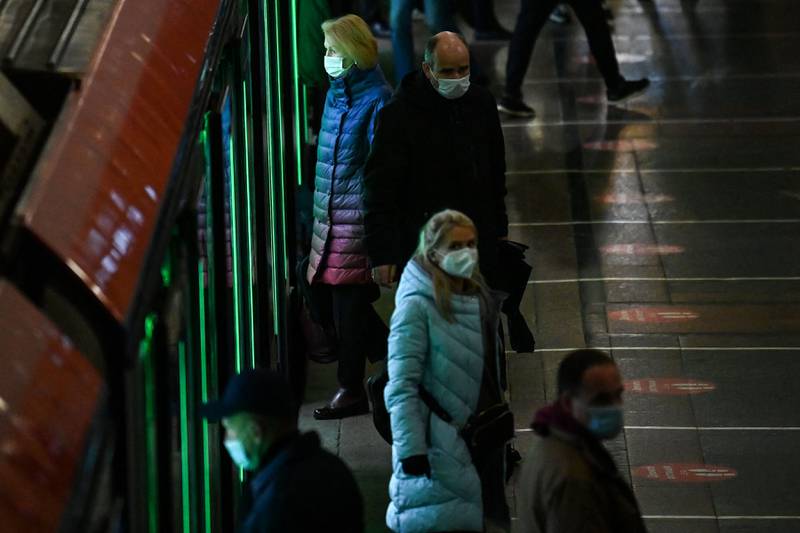 Passengers wear face masks on a metro train platform in Moscow, Russia. AFP