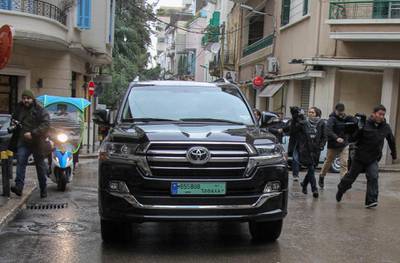 Journalists chase a car that left a house said to belong to former Nissan chief Carlos Ghosn in Beirut. AFP