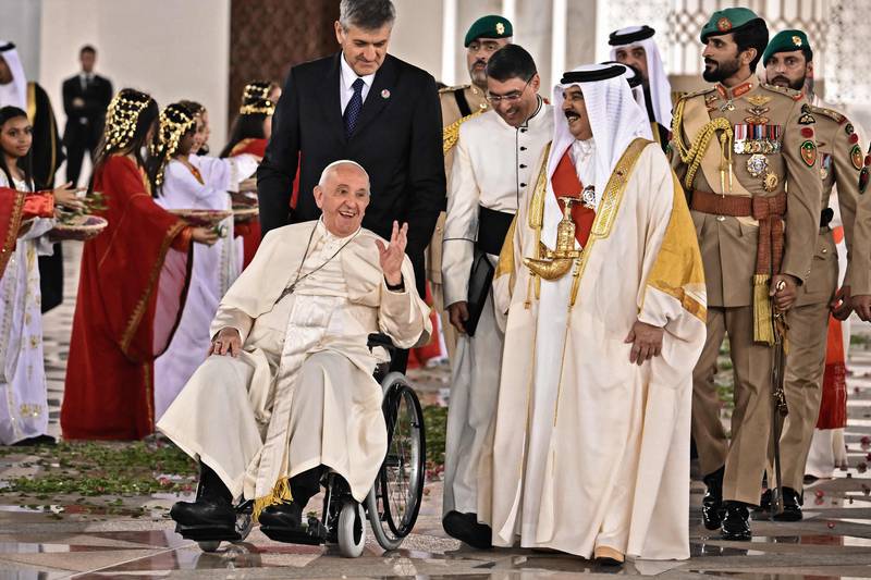 Pope Francis is escorted by Bahrain's King Hamad as he leaves the Royal Palace in the capital Manama on November 3. AFP