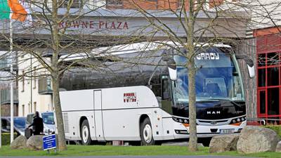 A bus leaves the Crowne Plaza hotel after dropping off airline passengers. Getty Images