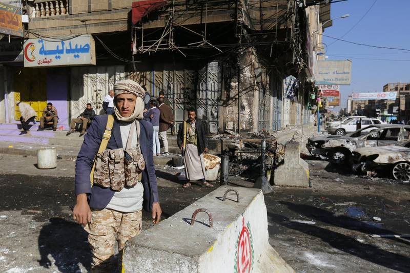 Armed Yemenis stand guard at a street leading to the residence of Yemen’s ex-president Ali Abdullah Saleh a day after Houthi militants killed him, in Sana’a, Yemen. Yahya Arhab / EPA