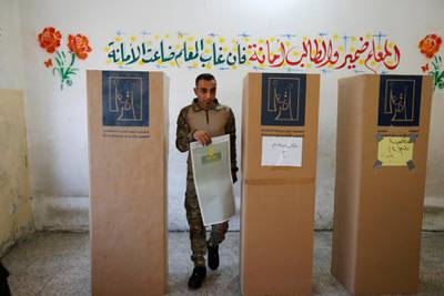 An Iraqi security member casts his vote at a polling station in Baghdad, Iraq.Thaeir al-Sudani / Reuters