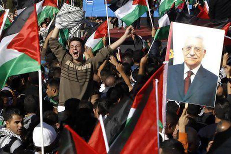 Palestinians in Ramallah cheer near a placard depicting Palestinian Authority president Mahmoud Abbas after the UN General Assembly upgraded their status from ‘observer entity’ to ‘non-member state’.
