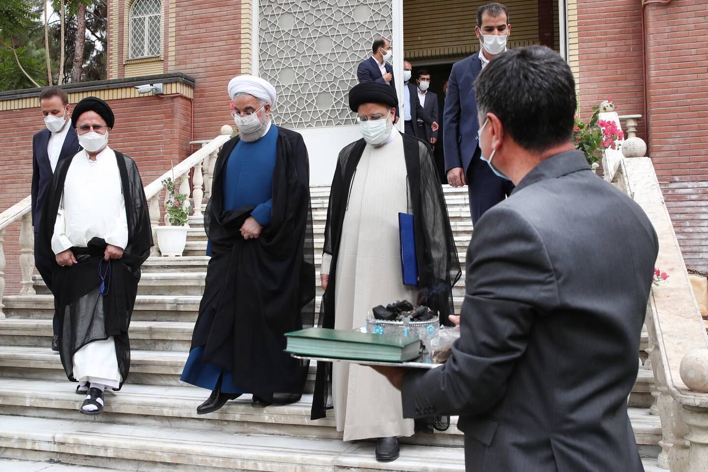 Outgoing president Hassan Rouhani  walking with Iran's newly inaugurated President Ebrahim Raisi 