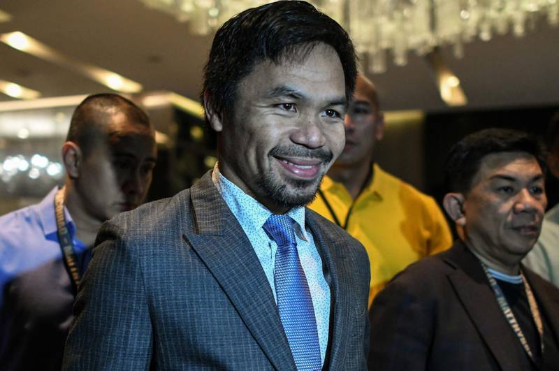 Filipino boxing idol Manny Pacquiao (C) arrives for a press conference in Kuala Lumpur on April 20, 2018, ahead of his world welterweight boxing championship bout against Argentina's Lucas Matthysse in July.  / AFP PHOTO / Mohd RASFAN