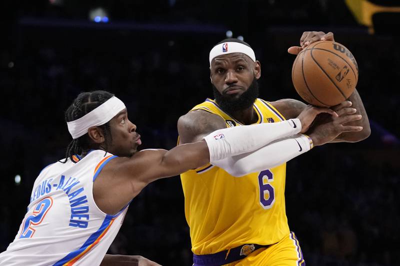 Los Angeles Lakers forward LeBron James, right, is fouled by Oklahoma City Thunder guard Shai Gilgeous-Alexander. AP