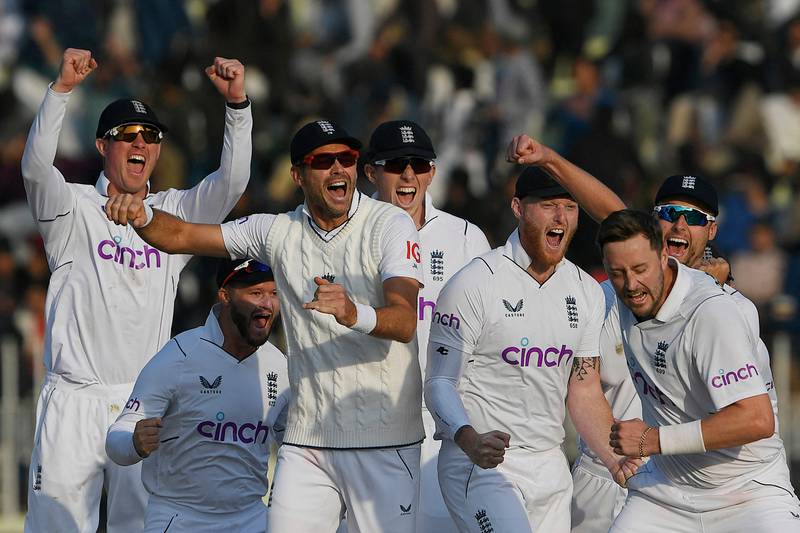 England players celebrate after the dismissal of Pakistan's Salman Ali Agha during the fifth and final day of the first Test at the Rawalpindi Cricket Stadium on December 5, 2022. AFP