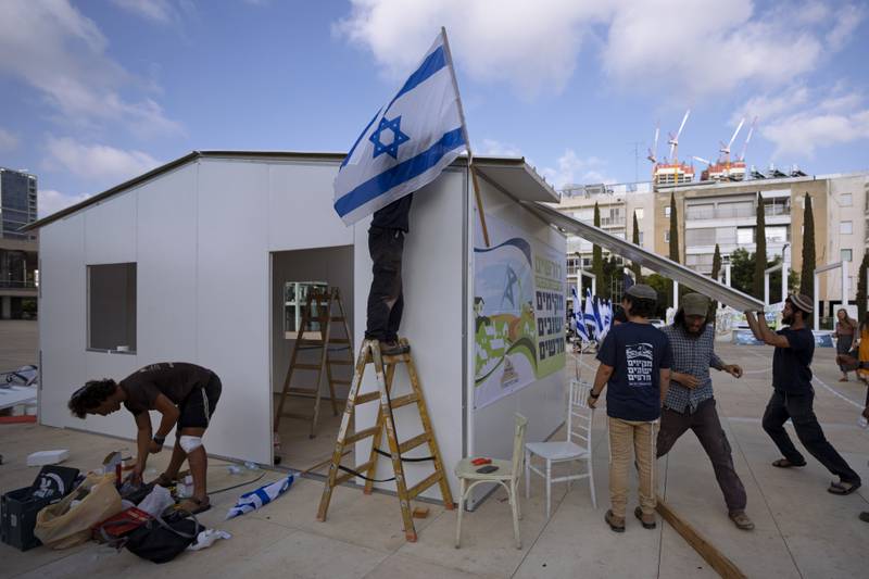 Right-wing Israeli activists from the Nachala Settlement Movement put up a temporary structure at Habima Square in Tel Aviv on July 12, in a protest calling for the establishment of new Jewish settlements in the occupied West Bank. AP