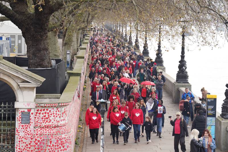Bereaved families gathered on Tuesday to mark the first anniversary of the National Covid Memorial Wall in London. They walked to No.10 Downing Street to hand in a petition to make the mural a permanent addition to the capital. PA