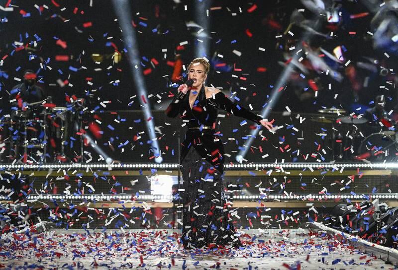 Adele stands on stage as confetti falls in Hyde Park. Getty Images
