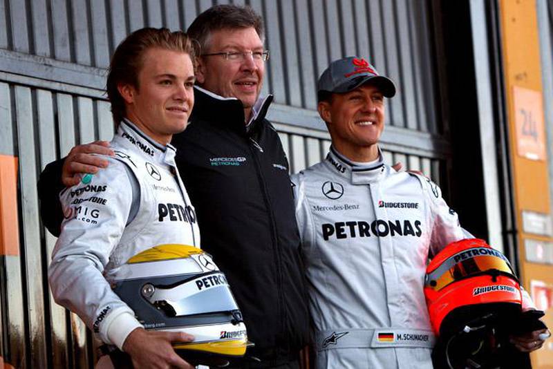 VALENCIA, SPAIN - FEBRUARY 01:  Nico Rosberg (L), team principal Ross Brawn and Michael Schumacher of Germany and Mercedes are posing for a photo at their new car presentation at the Ricardo Tormo Circuit on February 1, 2010 in Valencia, Spain.  (Photo by Vladimir Rys/Bongarts/Getty Images)