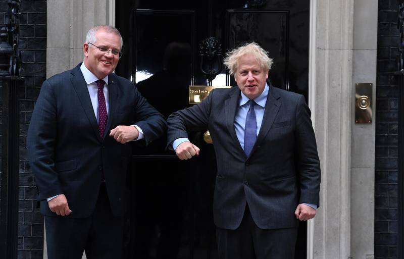 epa09271506 British Prime Minister Boris Johnson (R) welcomes Australian Prime Minister Scott Morrison (L) at 10 Downing Street in London, Britain, 14 June 2021.  EPA/ANDY RAIN