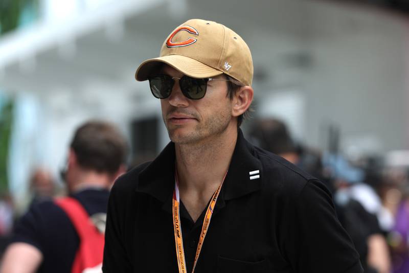 Actor Ashton Kutcher walks in the paddock prior to the F1 Grand Prix of Miami. Getty