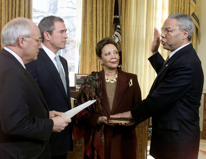 George W Bush watches his then-vice president Dick Cheney swearing in Powell as secretary of state designate at the White House, January 2001. Holding the bible is Powell's wife, Alma. Reuters