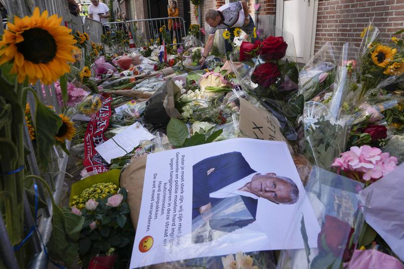 Tributes left at the scene where Dutch journalist Peter R de Vries was shot in Amsterdam in July 2021. AP