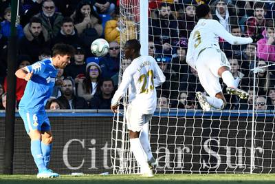 Getafe defender Leandro Cabrera, left, heads the ball as Real Madrid's Eder Militao, right, dives for it. AFP