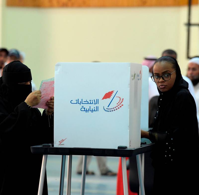 Two women cast their ballots at a polling station in Bahrain. AFP