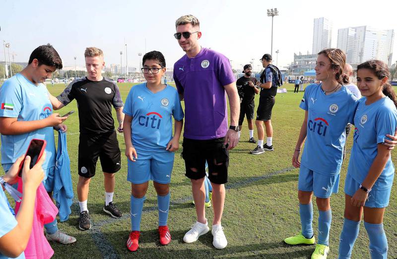 ABU DHABI, UNITED ARAB EMIRATES , Nov 30 – 2019 :- Students of Manchester City football school Abu Dhabi taking their photos with Aymeric Laporte, French footballer at the Zayed Sports city in Abu Dhabi. ( Pawan Singh / The National )  For Sports. Story by Jon Turner 