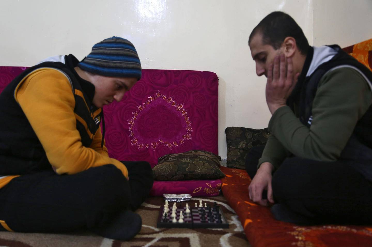 Mohammed Haj Ahmad (R), 23, plays chess with his roommate at the Syrian Centre for Countering Extremist Ideology in the Syrian town of Marea, in the northern Aleppo district, on November 30, 2017.
In the rehabilitation centre in northern Syria, young men huddle over an innocuous game of chess and some cigarettes -- activities they once brutally suppressed as Islamic State group jihadists.  / AFP PHOTO / Nazeer al-Khatib