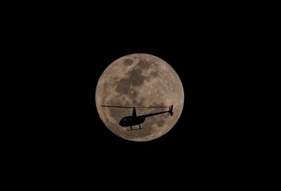 A helicopter in front of the blue supermoon in the city of Sao Paulo. EPA