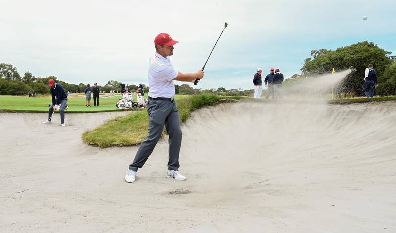 US player Bryson Dechambeau hits out of a bunker. AFP